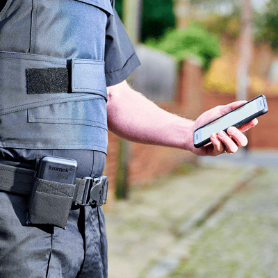 Security personnel with D3S ID on their belt and connected phone in hand