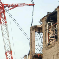 Crane by abandoned building