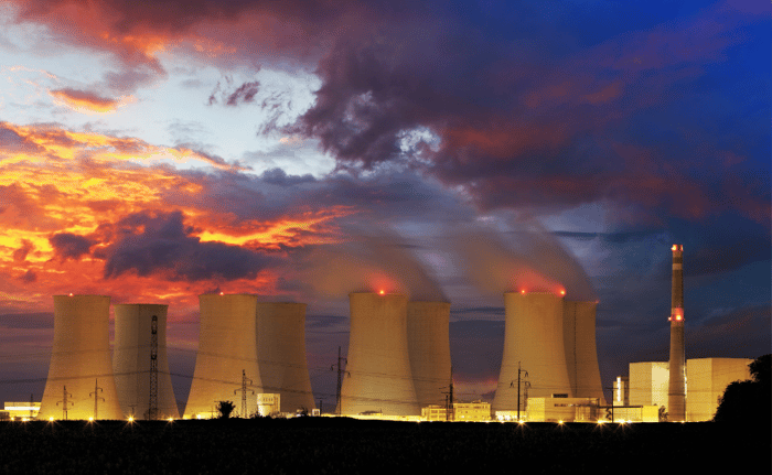 Nuclear power plant with a colourful orange, red and purple sky